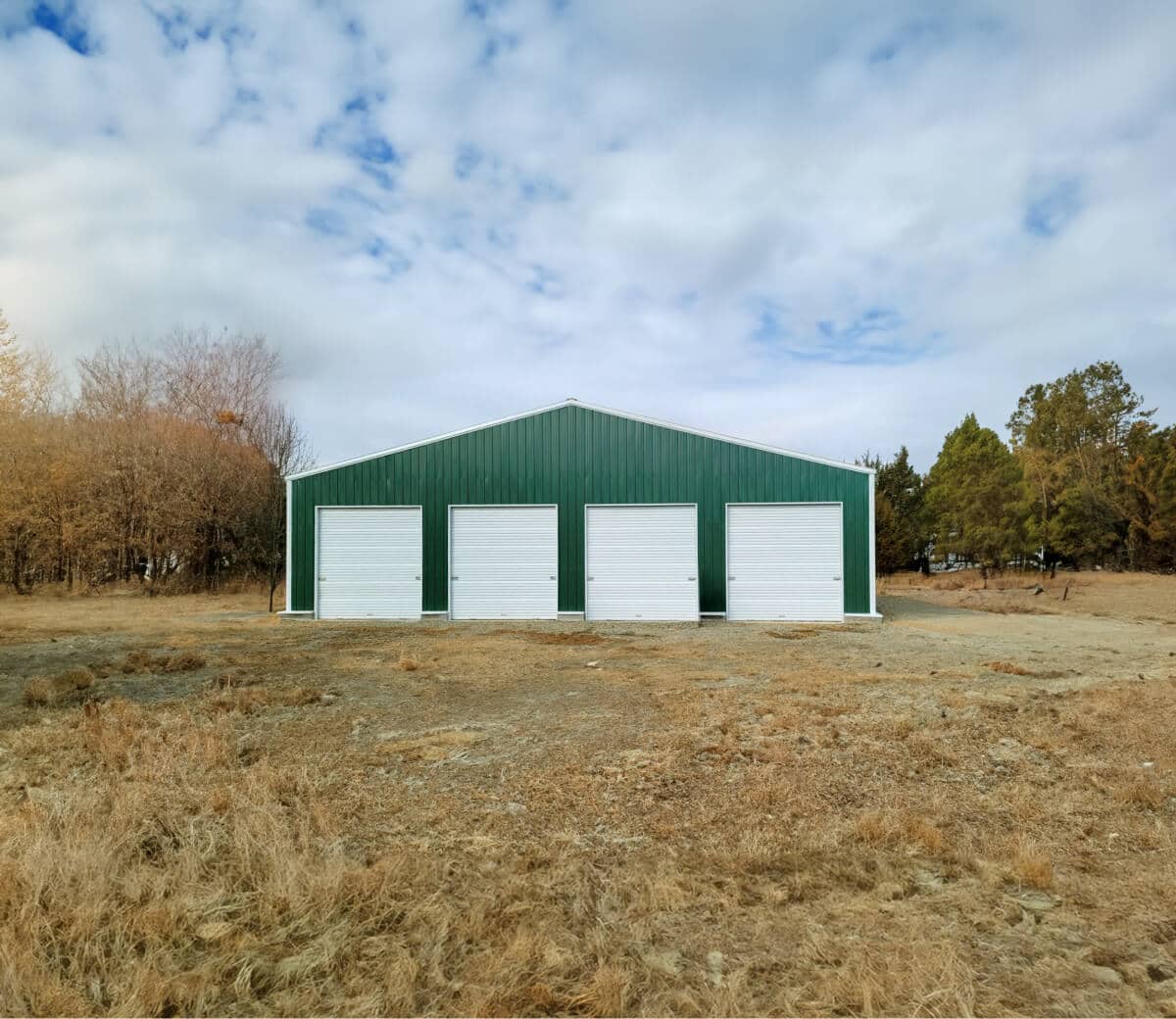 Green garage with four garage doors.