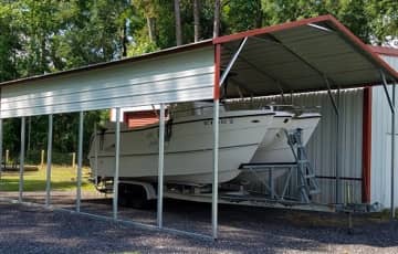A boxed-eave carport protects a boat