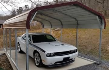 A brown regular-roof carport shelters a white sports car