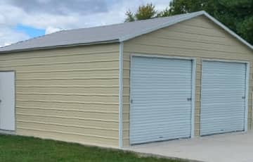 A red boxed-eave metal garage with white trim