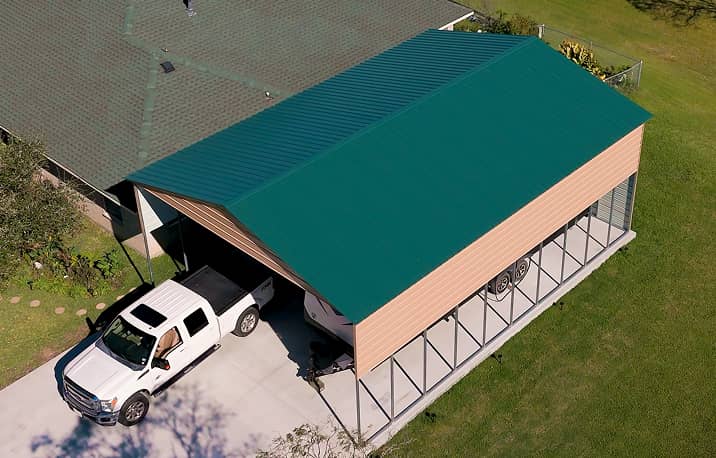 Vertical style roof metal carport covering white RV trailer
