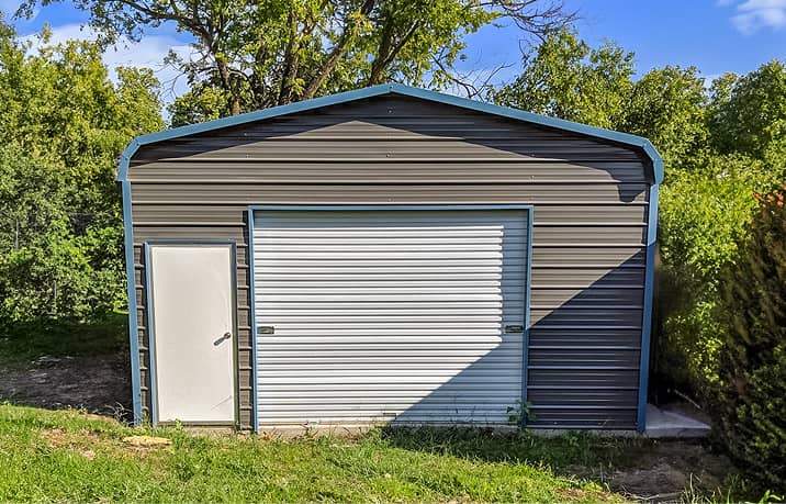 Regular style roof metal garage with two overhead doors and walk-in door