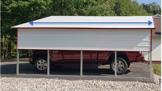 A white carport with a boxed-eave roof and partially enclosed sides shelters a red truck