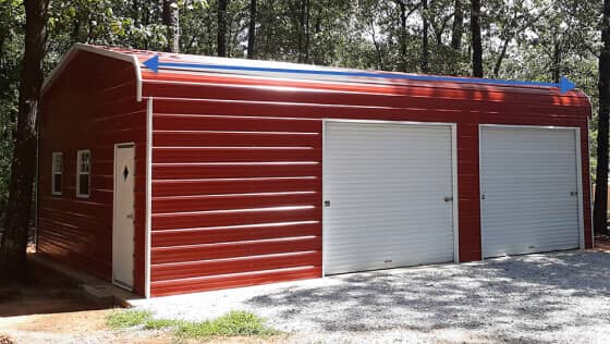 A red 2-car garage with a regular-style roof and white doors
