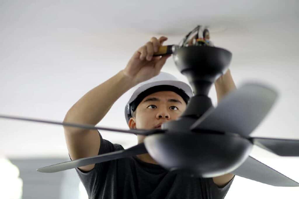 contractor installing fan in garage