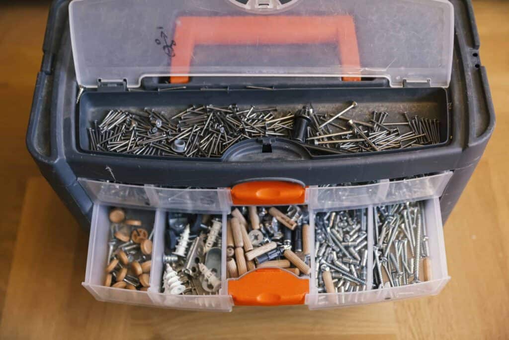 Open toolbox filled with assorted nails and screws.