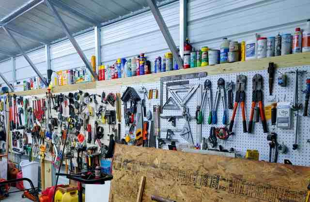 Various tools organized on a pegboard in a garage.