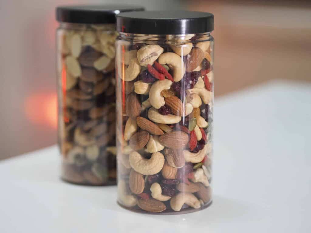 Cashews and almonds in plastic containers for food storage