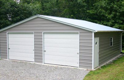 A gray 30x40 metal building with two white garage doors
