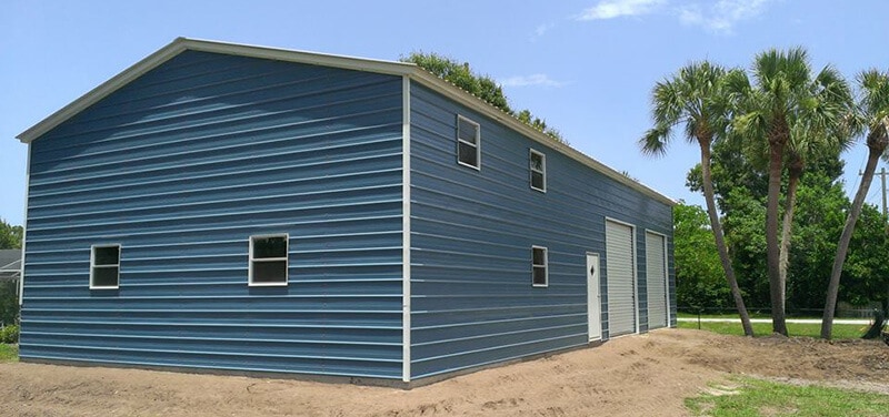 A 30x30 blue metal garage with multiple doors and windows