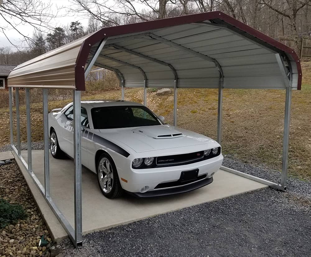 A pic of a car stored under a mobile home metal carport