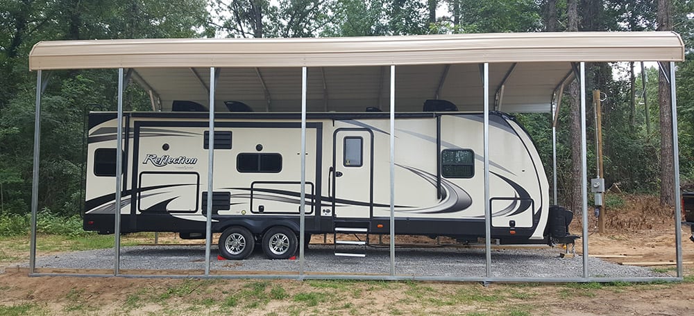 A motor home stands under a beige metal RV carport