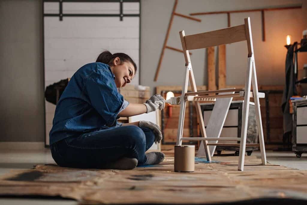 woman painting a chart in garage workshop