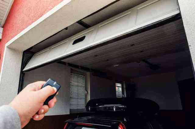 person opening garage of two cars