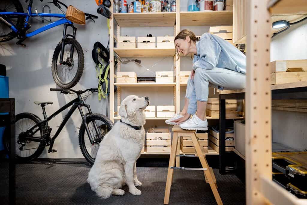 woman sitting in garage with her dog