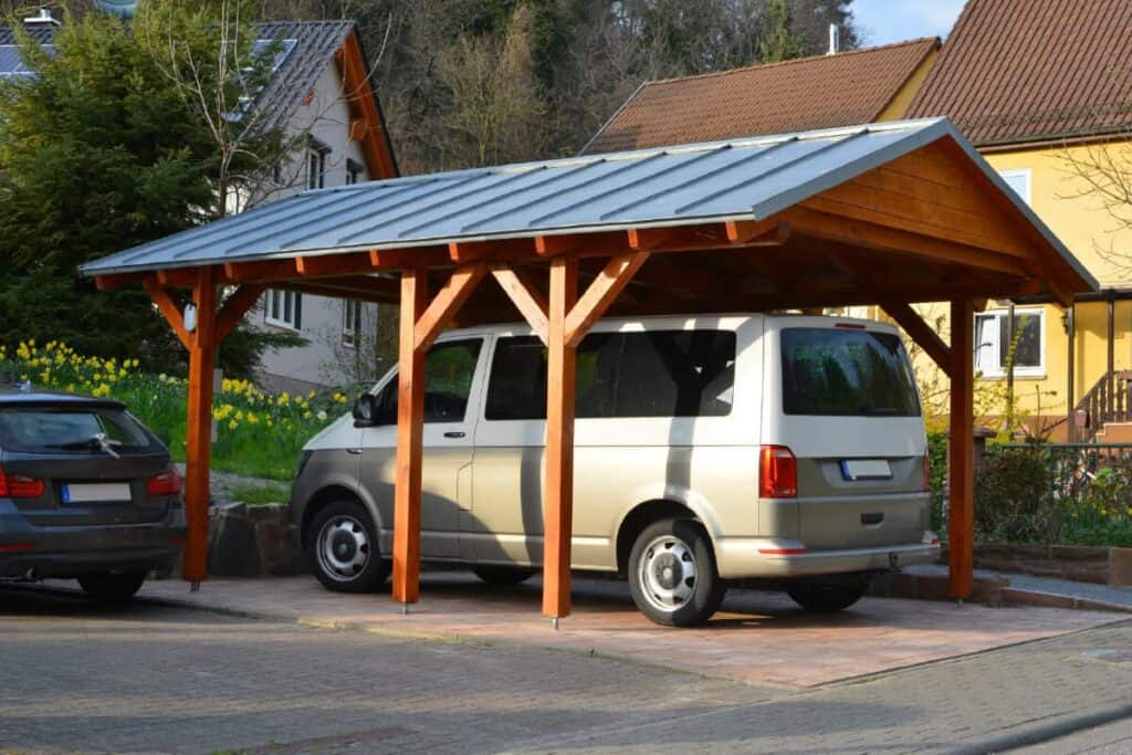 van parked under wooden carport