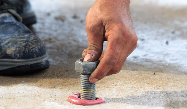 a person anchoring a carport