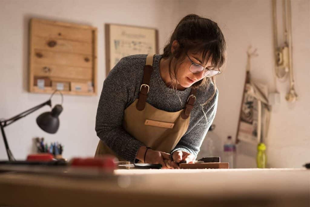 woman doing woodwork in shed