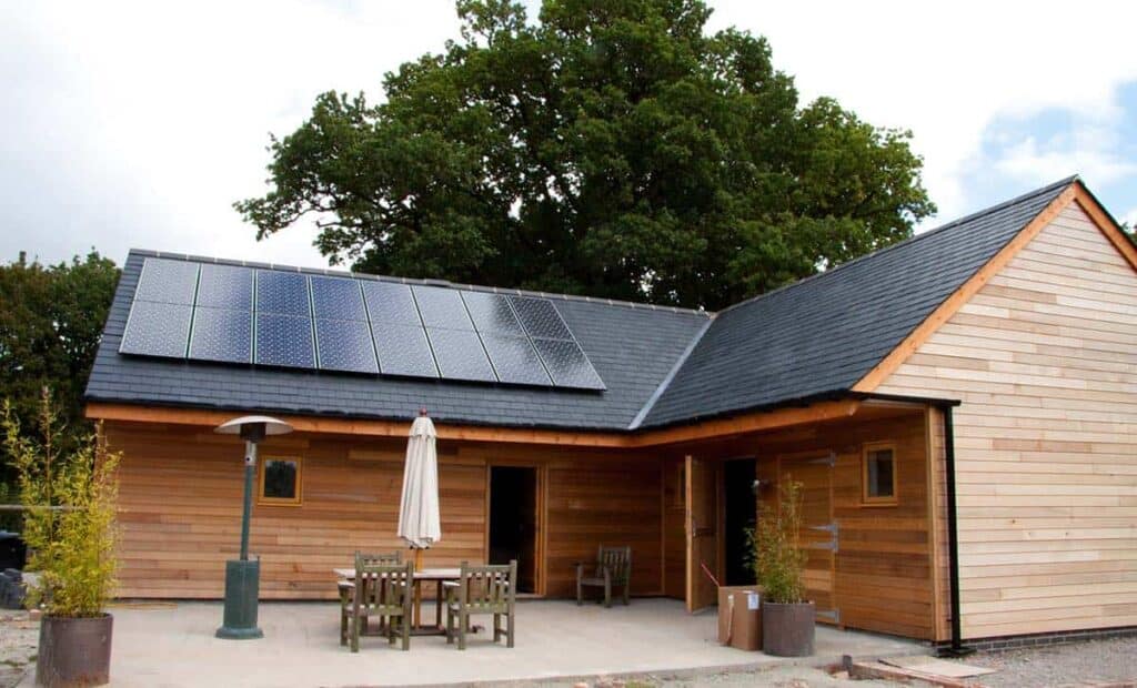 slat sliding barn home with solar panels on roof
