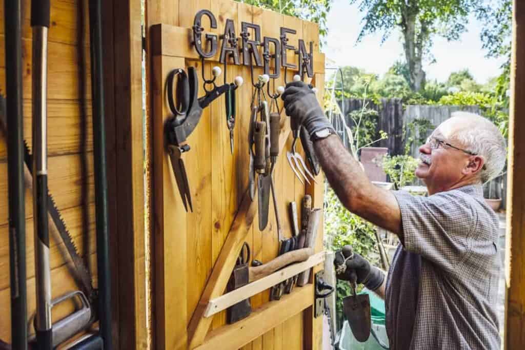 man opening wooden garden shed