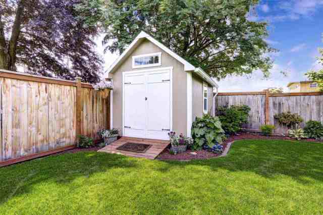 tan garden shed in backyard