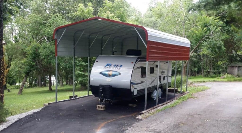 RV travel trailer under red carport