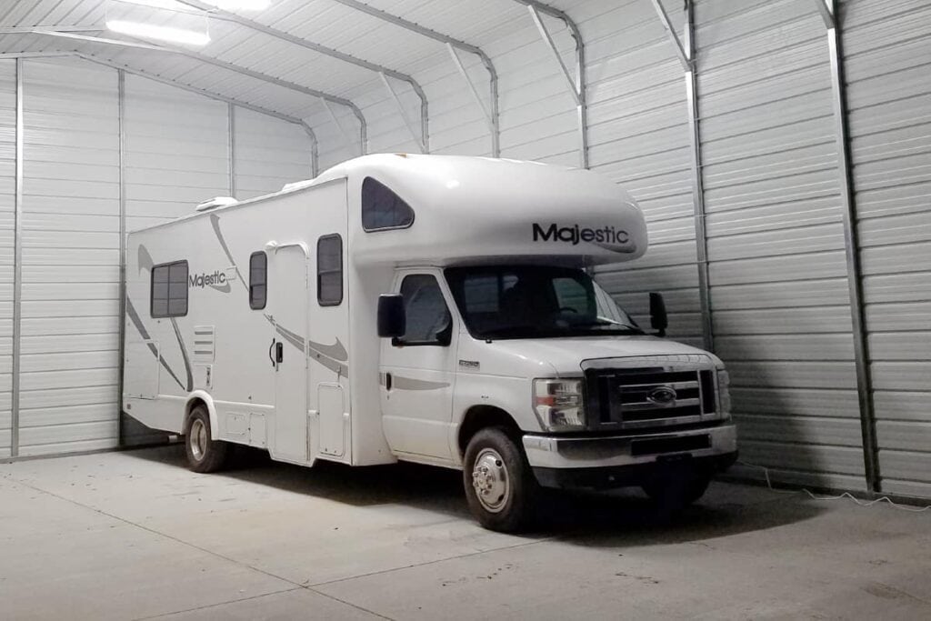 white RV parked inside of garage