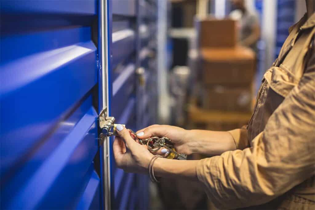 woman opening storage unit with key