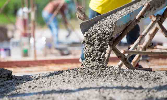 workers mixing and pouring concrete