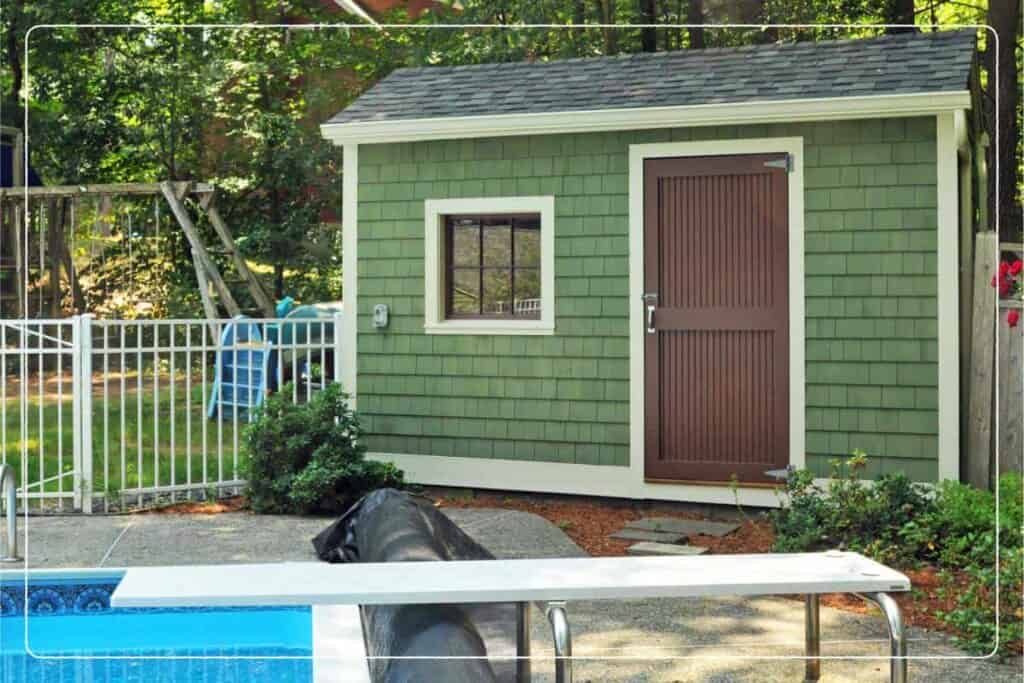 green pool house shed in next to backyard pool