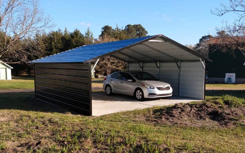 extended red metal carport with camper parked beneath