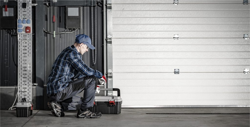 technician fixing a garage door