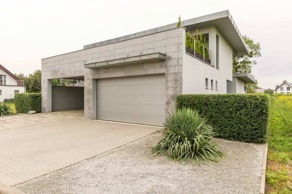 gray garage with a storage room attached