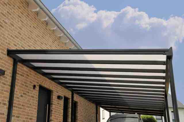 metal carport next to brick building