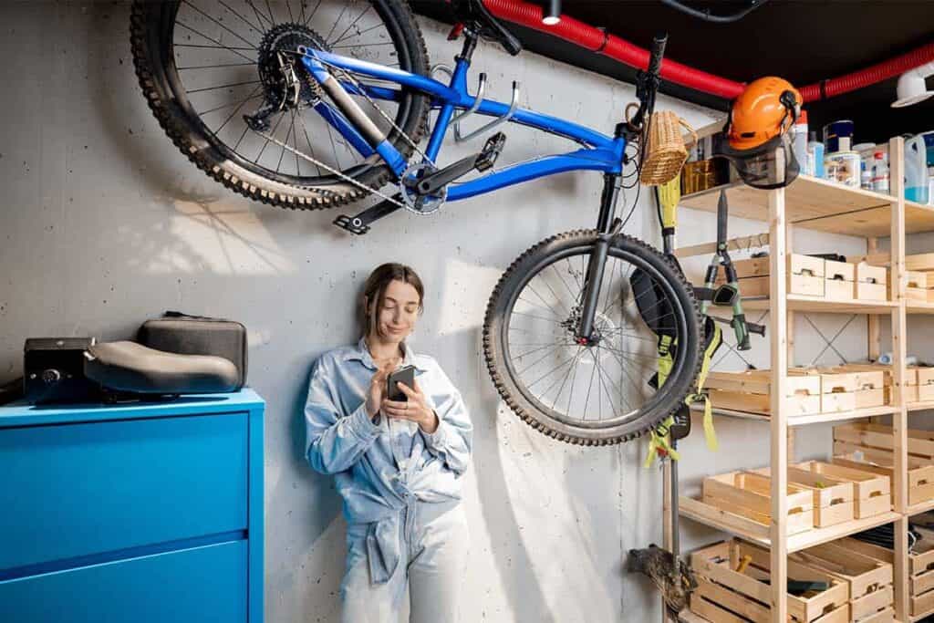 woman in garage beside next to a mounted bike