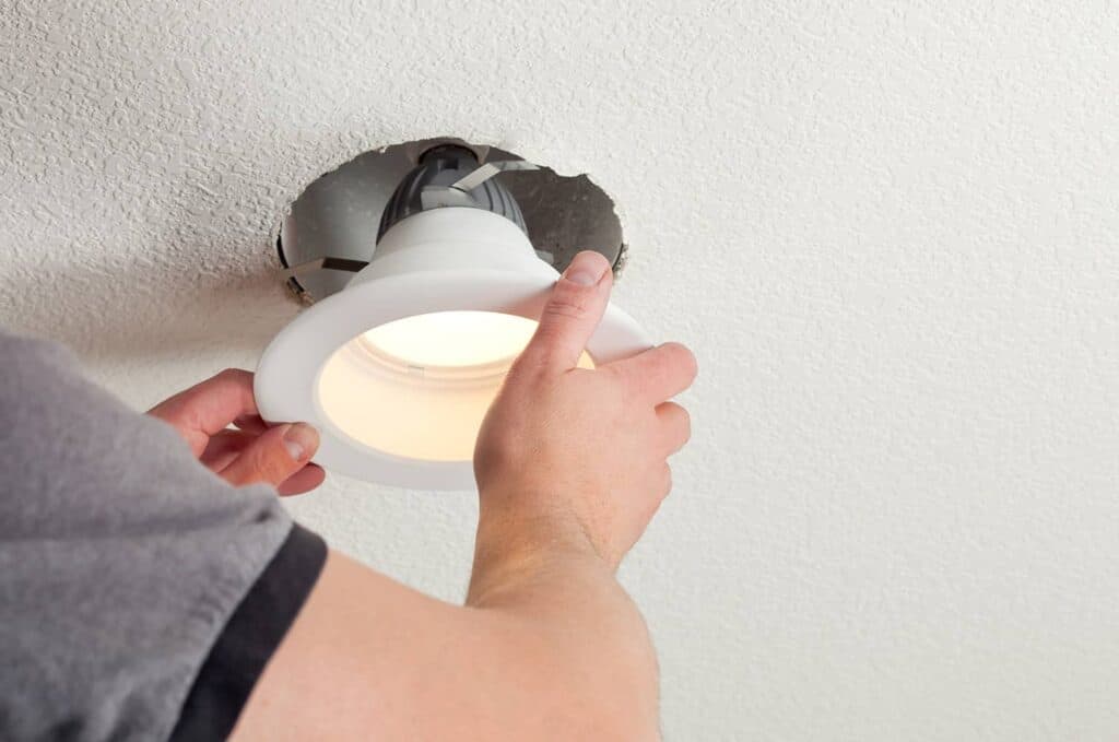 person installing recessed lighting