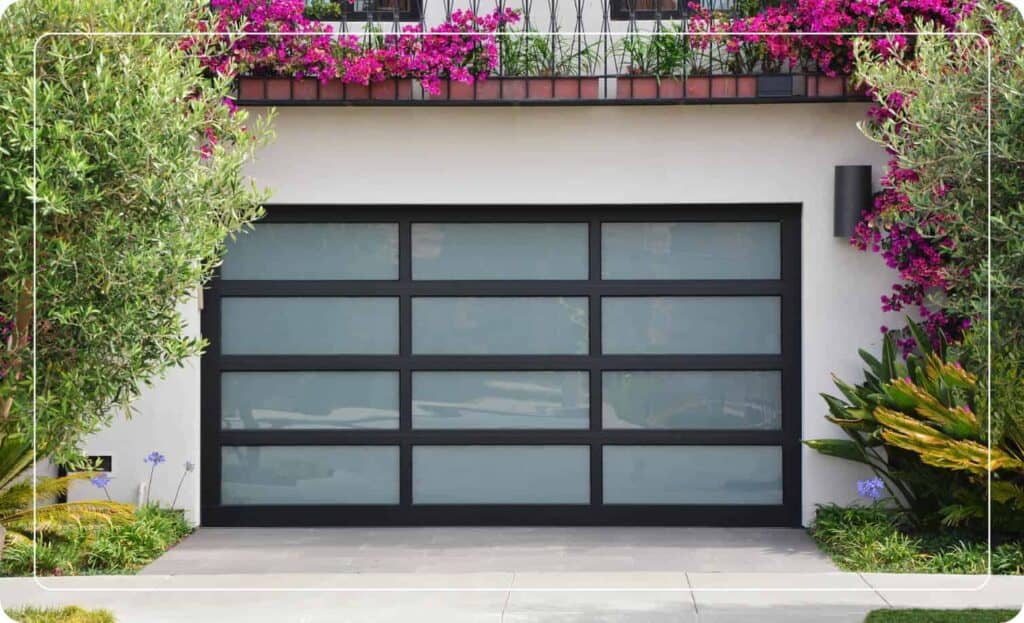 glass garage door with surrounding plants