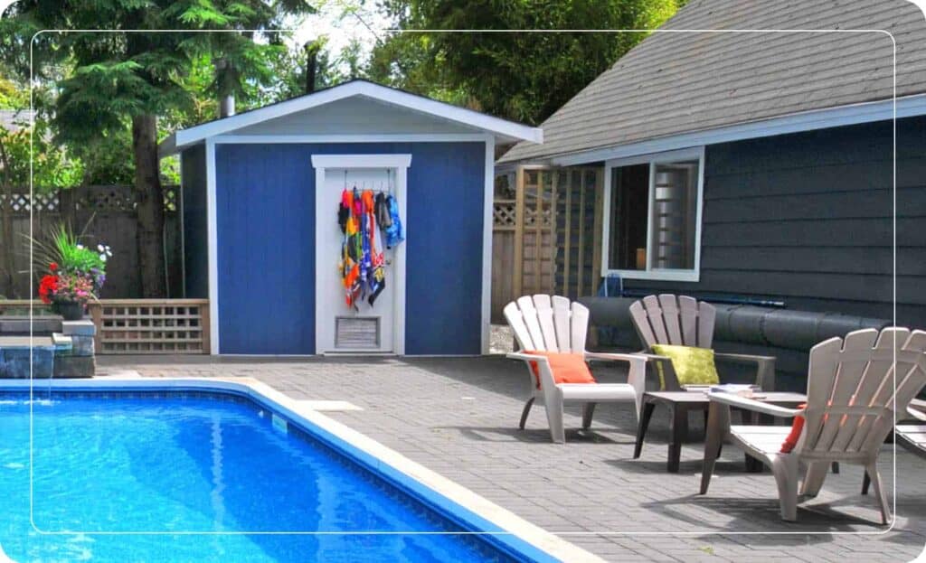 blue backyard shed with door hooks next to pool