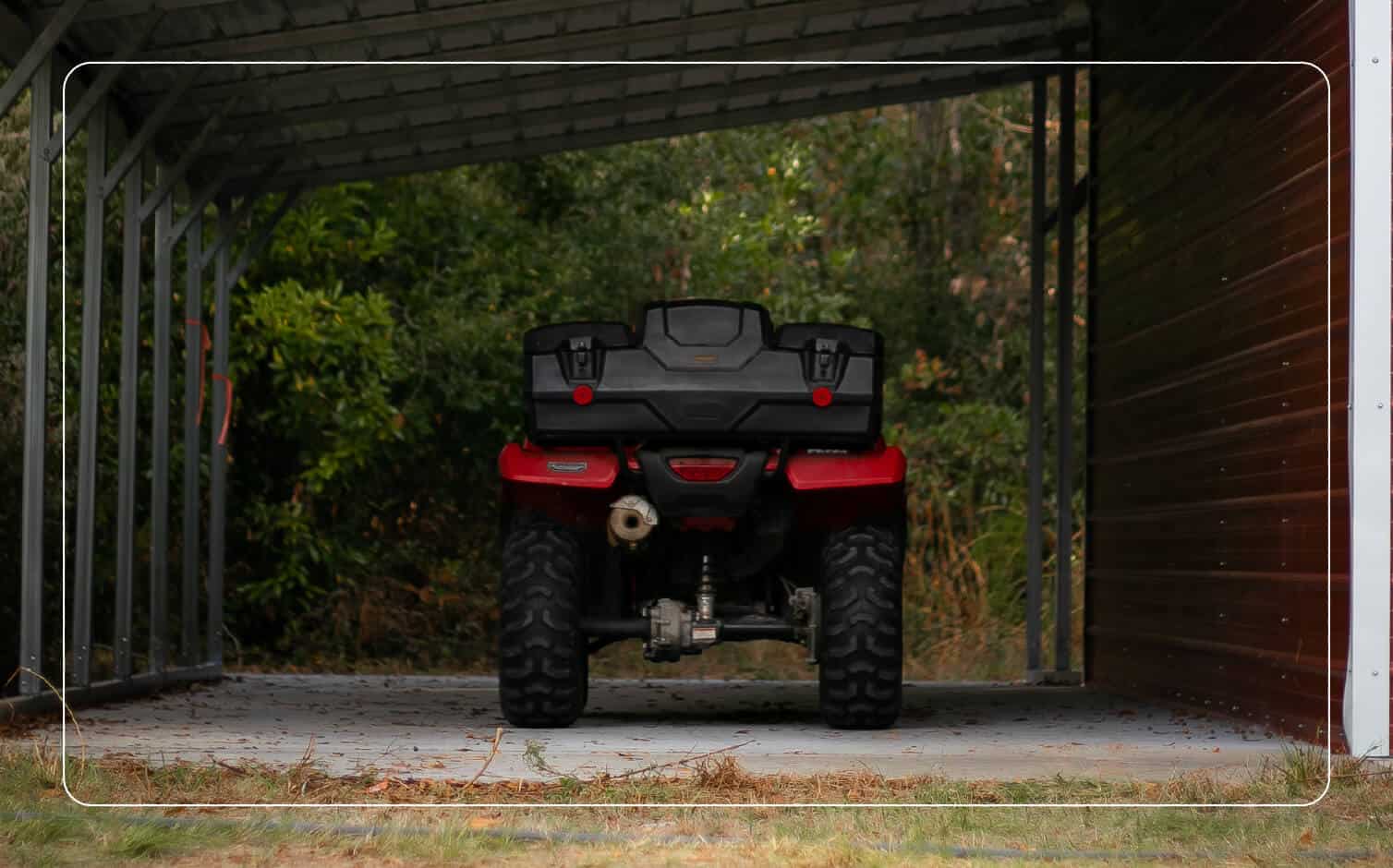 An image of a red ATV beneath a carport.