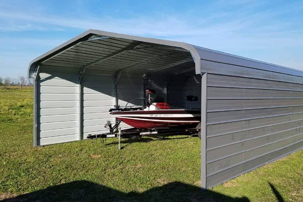 boat in a metal carport with enclosed sides