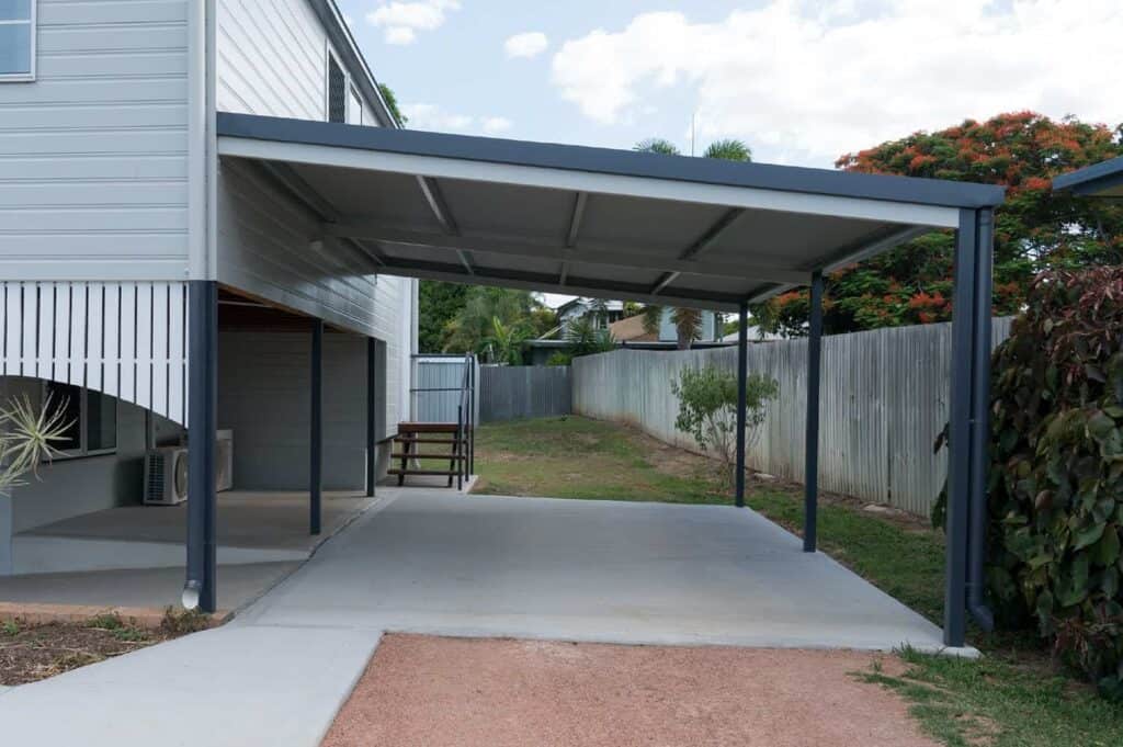 lean-to carport attached to a gray house