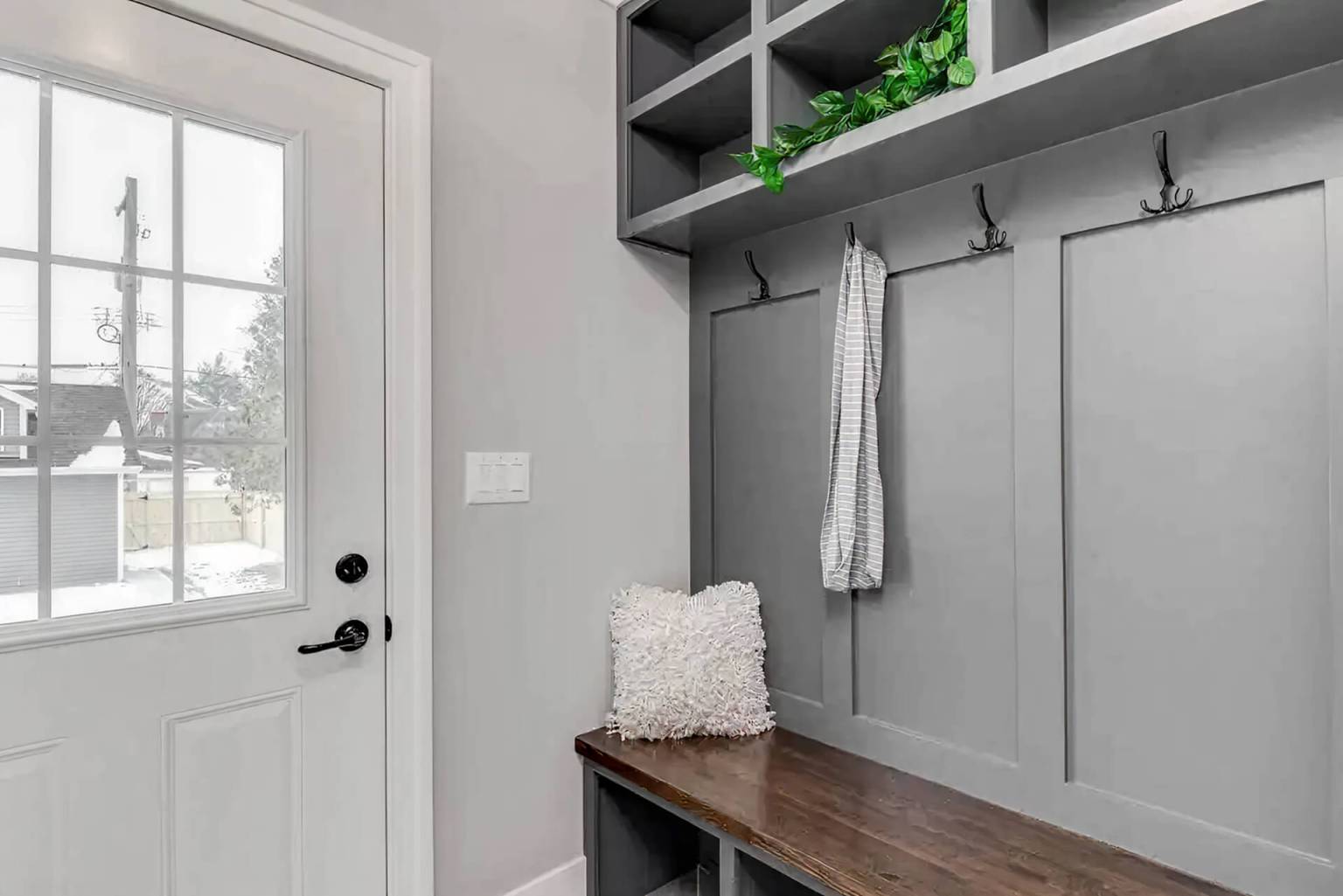 Gray mudroom with shoe storage.