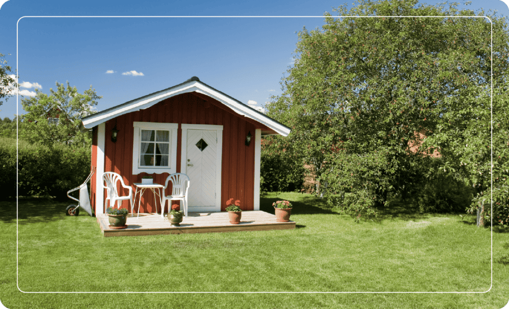 red shed with front porch and clean landscaping