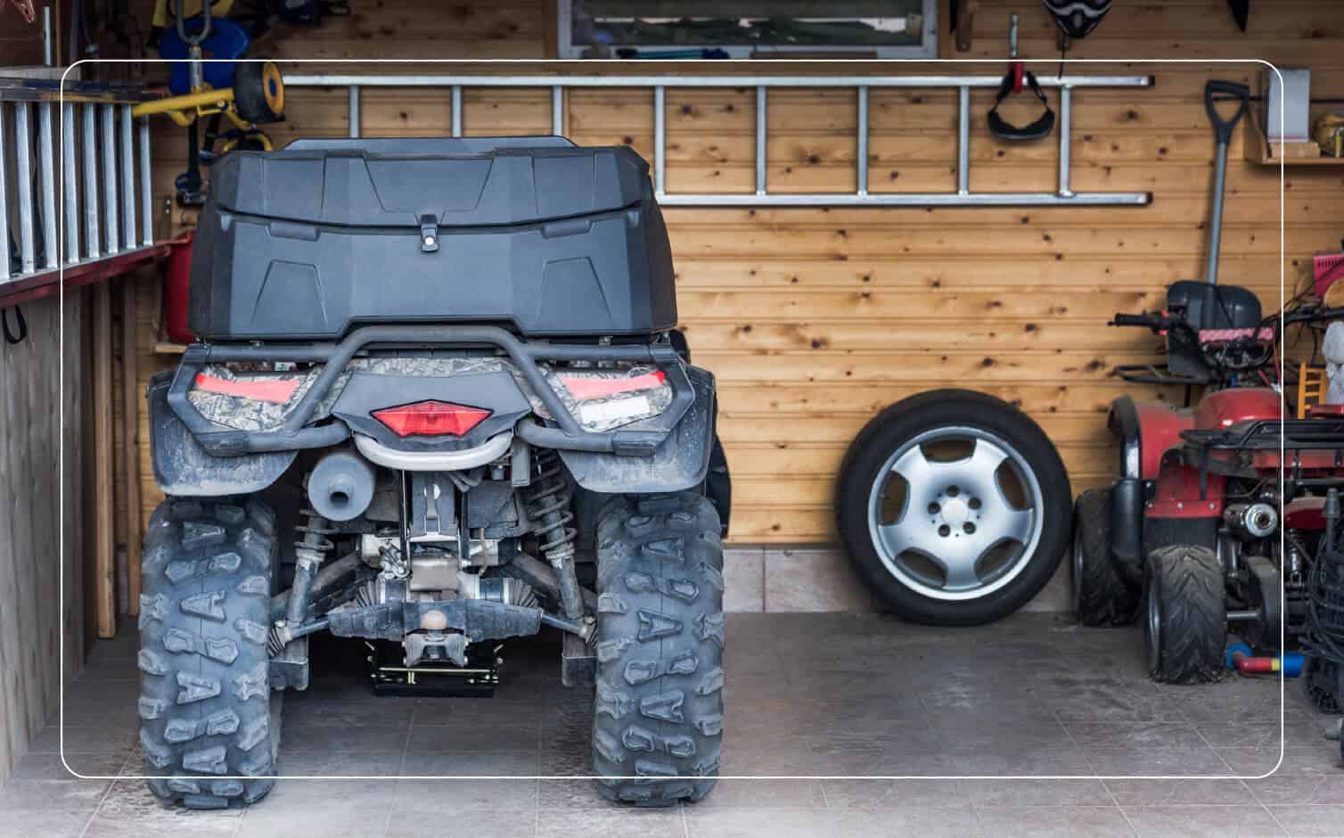 An image of a black ATV in a garage.