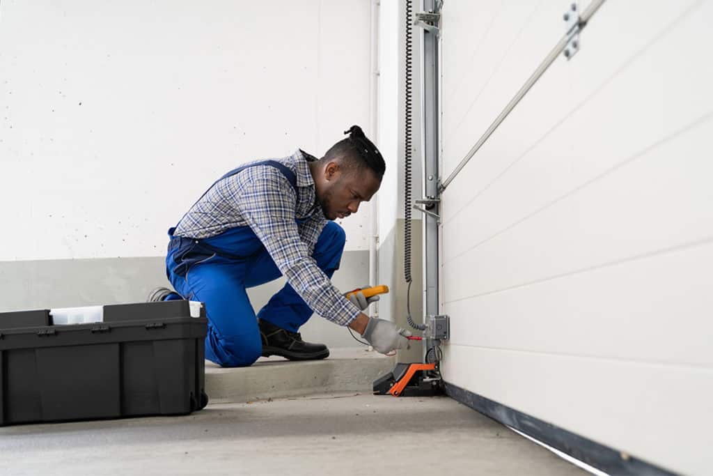 male contractor fixing 2-car garage door opener