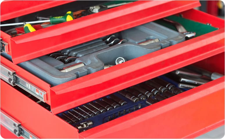 A toolbox with multiple drawers with wrenches and socket wrenches inside