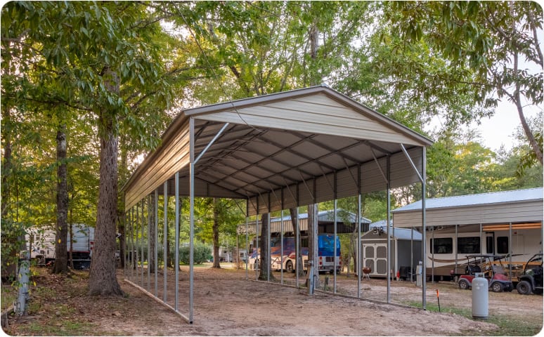 A metal carport surrounded by trees