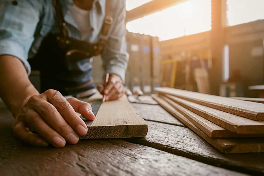 A woodworker preparing to cut a board.
