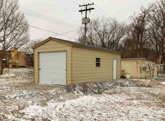 Alans Factory Outlet shed with a light snow surrounding the shed.