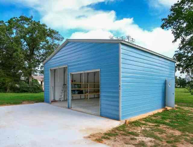 Blue garage with two garage doors.